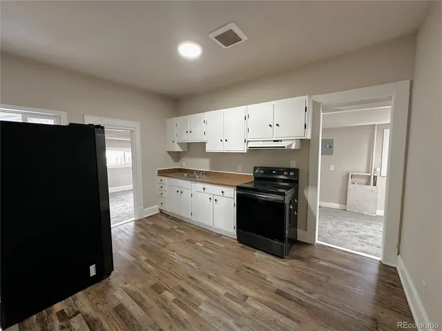 an empty room with closet and wooden floor