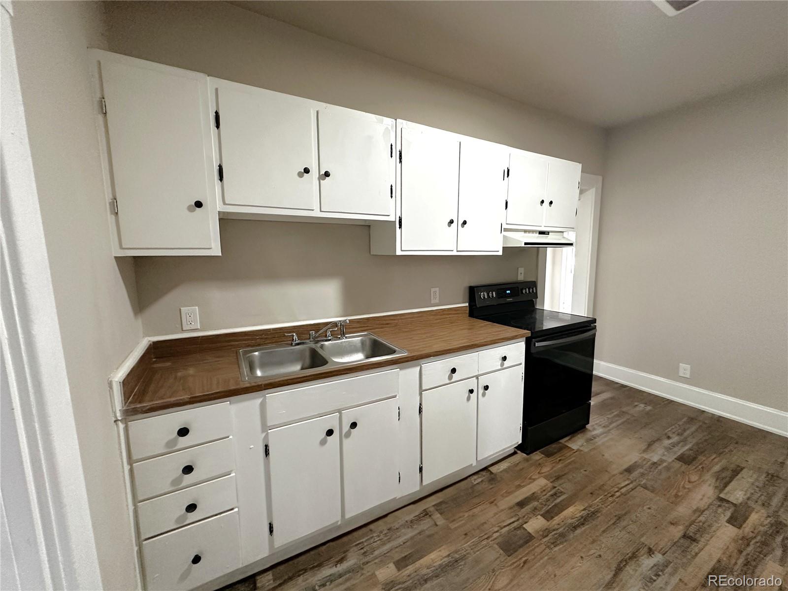 672 4th Street Limon, CO 80828 - Photo 20 of 28 a kitchen with granite countertop white cabinets and sink
