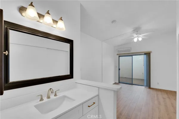 a bathroom with a sink vanity and a mirror