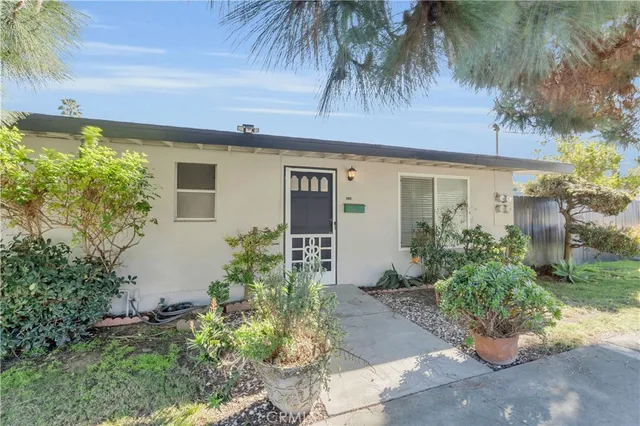 front view of a house with a potted plant