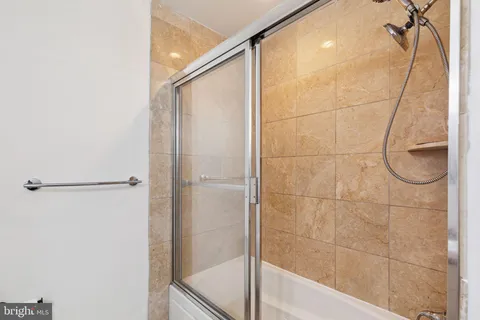 a bathroom with a glass shower door