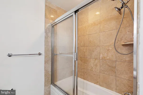 a bathroom with a glass shower door