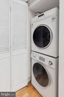 a view of a hallway with washer and dryer