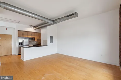 a kitchen with stainless steel appliances a refrigerator and a stove top oven