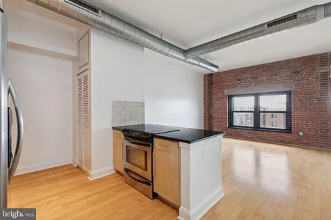 a kitchen with stainless steel appliances granite countertop a stove and a refrigerator