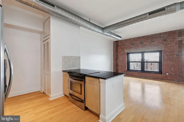 a kitchen with stainless steel appliances granite countertop a stove and a refrigerator