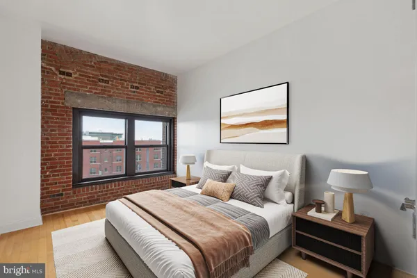 a bedroom with a bed and a large window