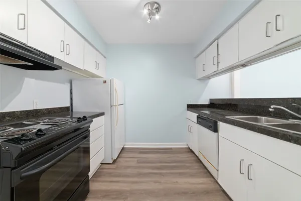 a kitchen with granite countertop a stove and a sink