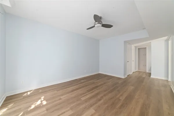 a view of empty room with wooden floor