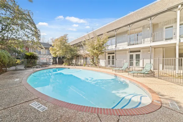 a view of a swimming pool with a lounge chairs