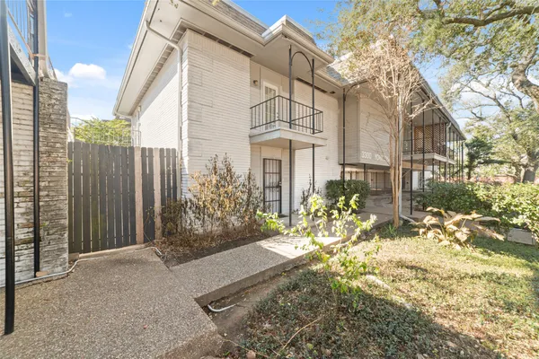 a view of a house with a yard and garden