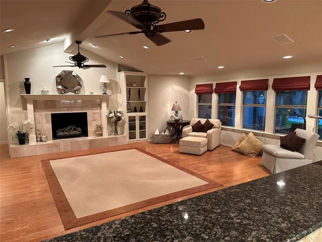a large bedroom with furniture and a fireplace