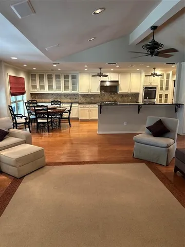 a living room with furniture and kitchen view