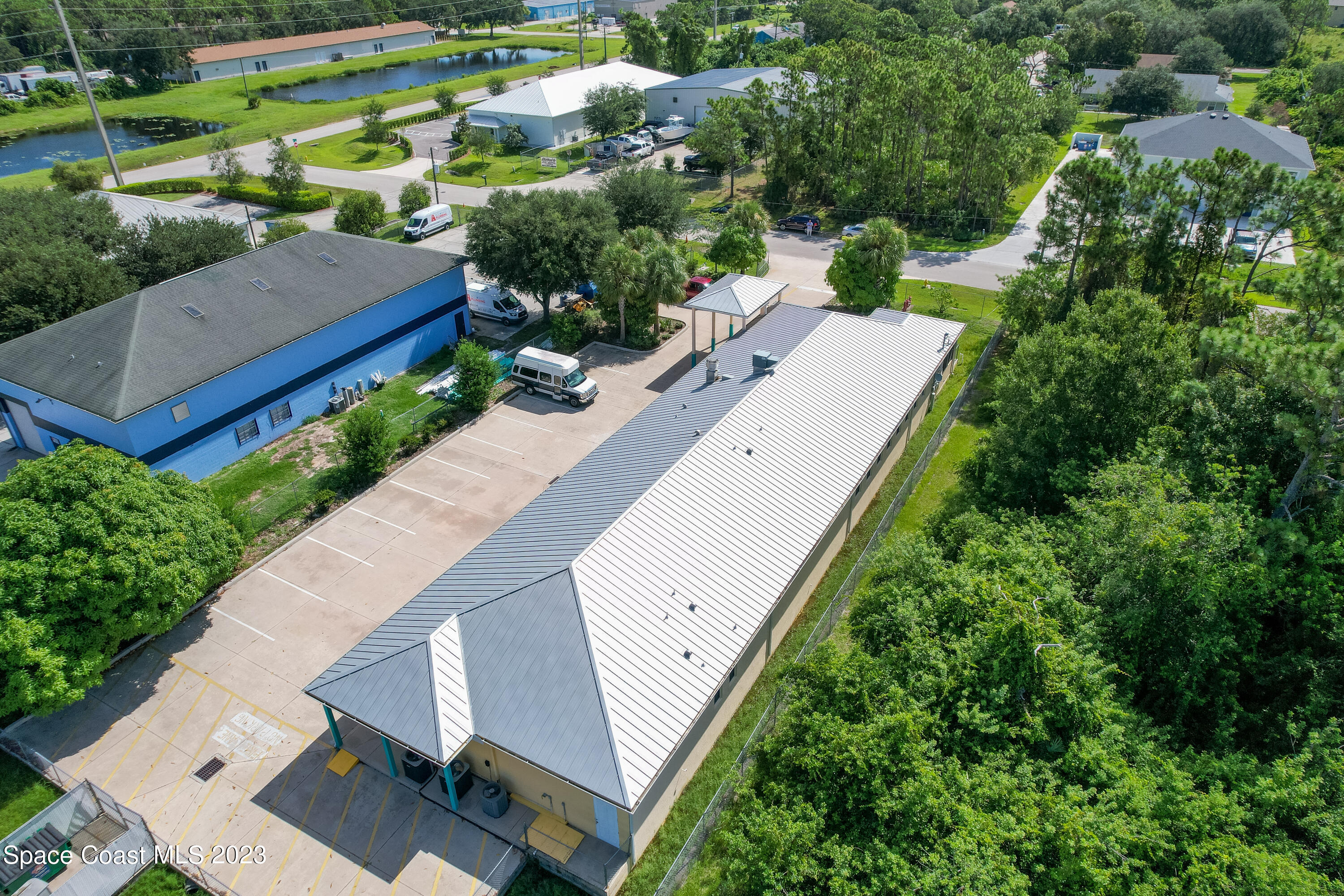 422 Martin Road Palm Bay, FL 32909 - Photo 11 of 37 an aerial view of a house with a yard and outdoor seating
