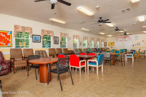 a view of a dining area with furniture and a chandelier