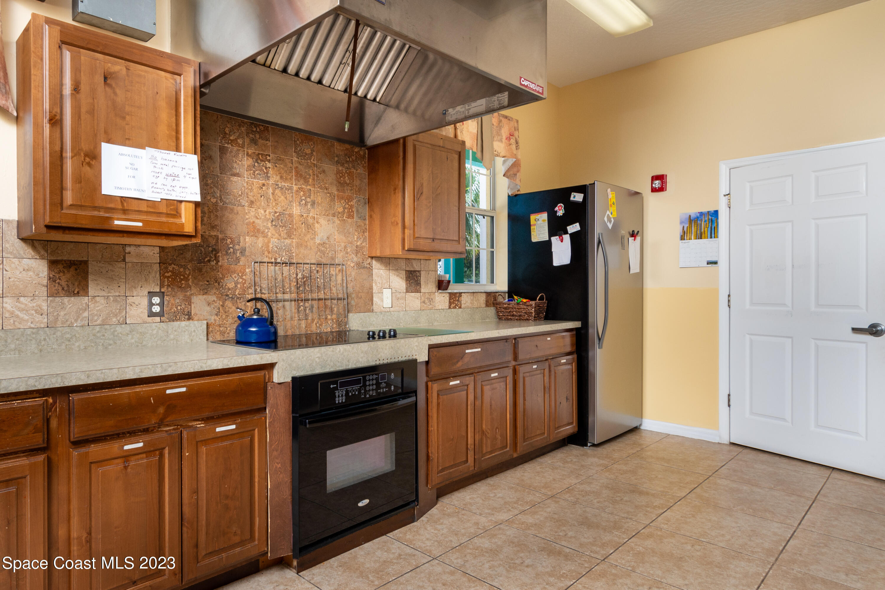 422 Martin Road Palm Bay, FL 32909 - Photo 20 of 37 a kitchen with stainless steel appliances granite countertop a sink and cabinets