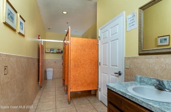 a view of a bathroom with a shower and mirror