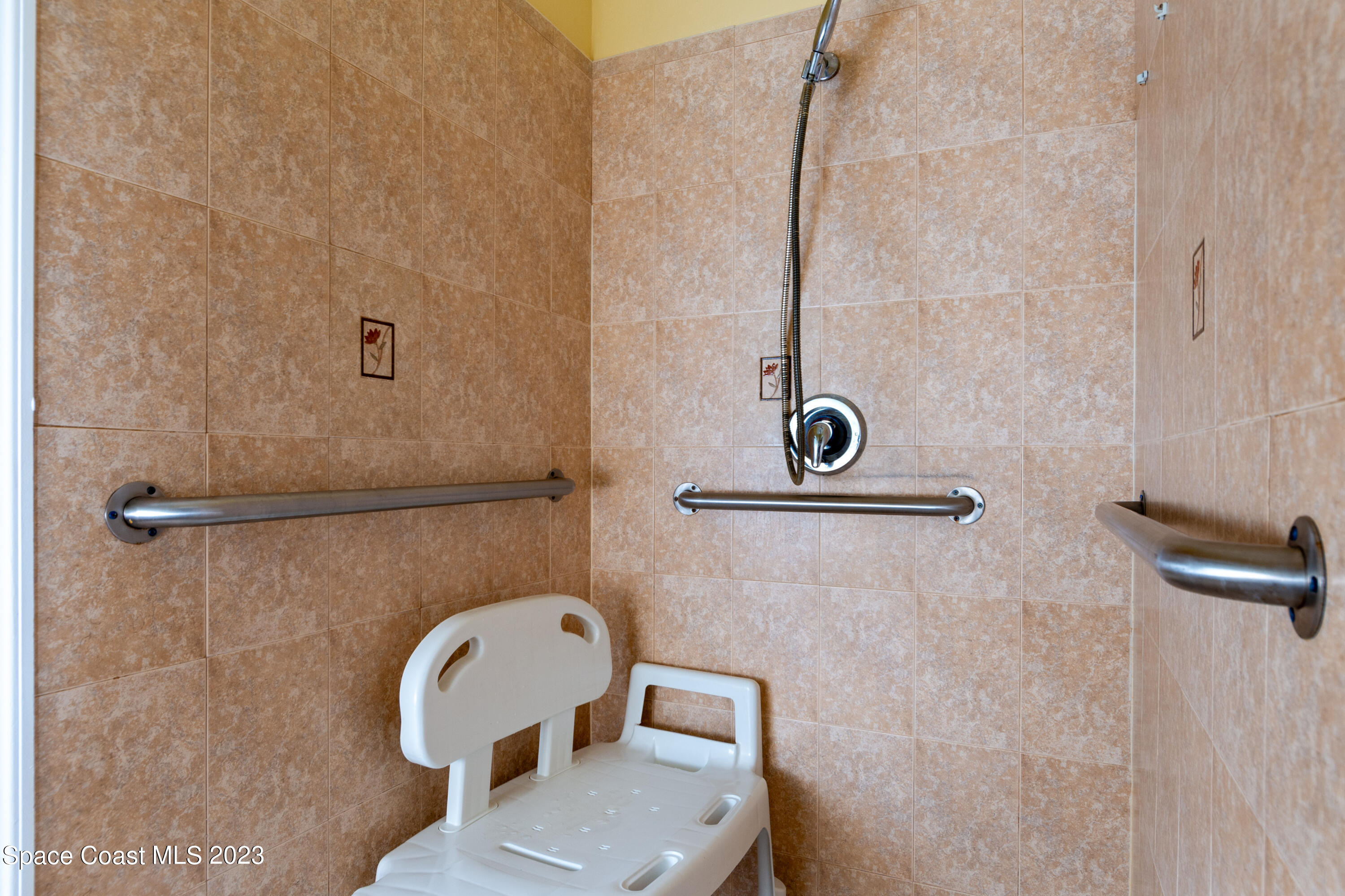 422 Martin Road Palm Bay, FL 32909 - Photo 23 of 37 a view of a bathroom with a shower and mirror