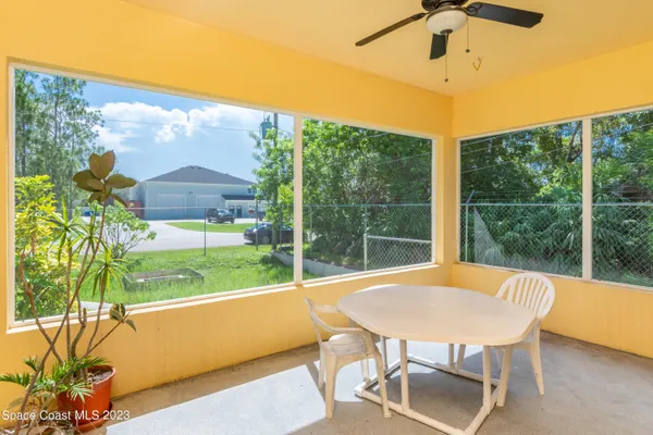 a view of a room with porch and a backyard