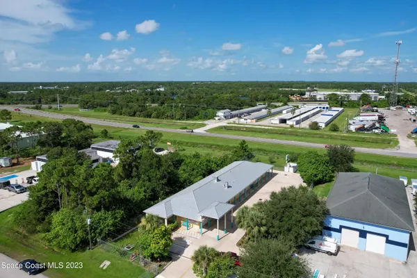 an aerial view of a house with garden space and street view