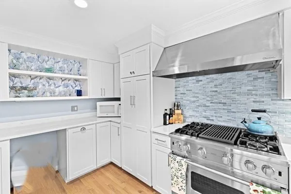 a kitchen with stainless steel appliances granite countertop a stove and a refrigerator