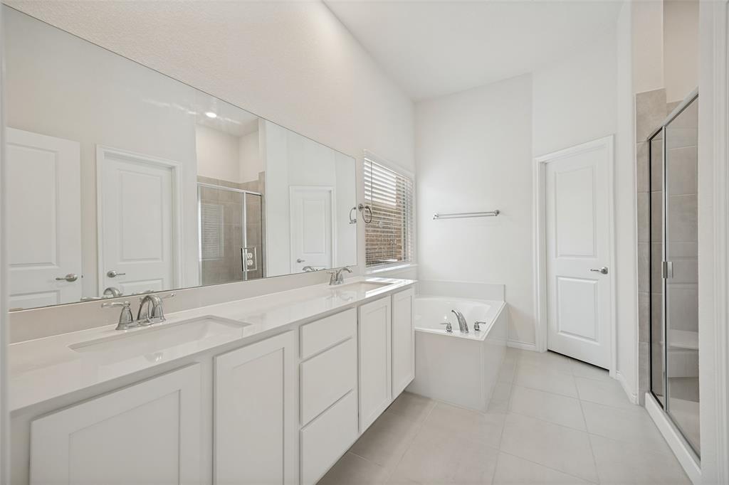 3816 Blacksmith Road Aubrey, TX 76227 - Photo 11 of 30 Dual vanity with white cabinetry, integrated sinks, and chrome fixtures