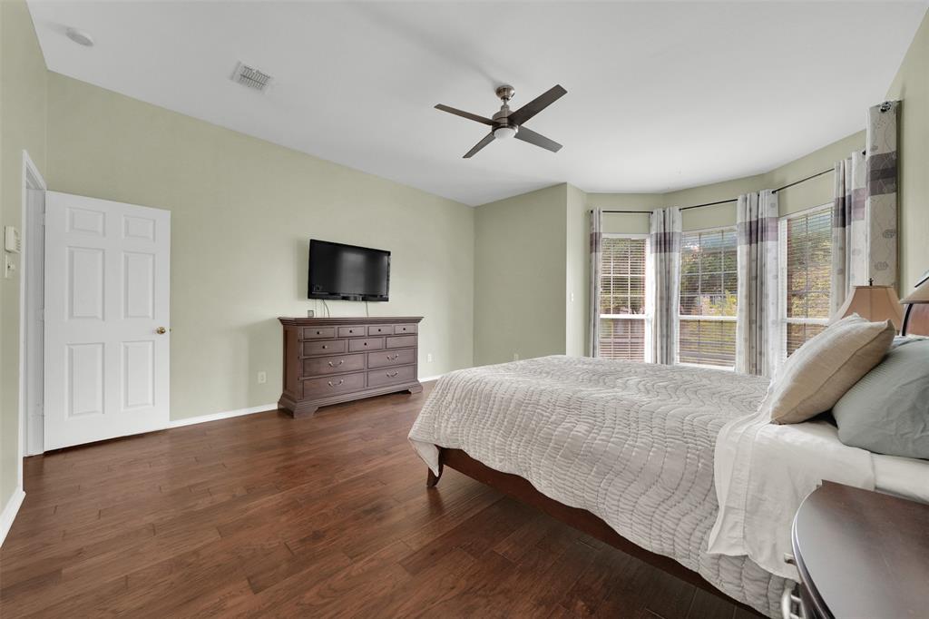 1333 Lighthouse Lane Allen, TX 75013 - Photo 18 of 40 a living room with a bed furniture and a flat tv screen