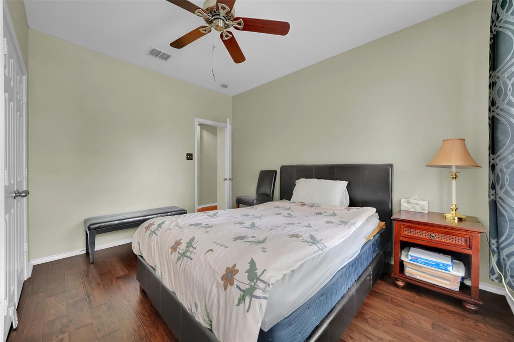 1333 Lighthouse Lane Allen, TX 75013 - Photo 25 of 40 a bedroom with a bed and a chandelier