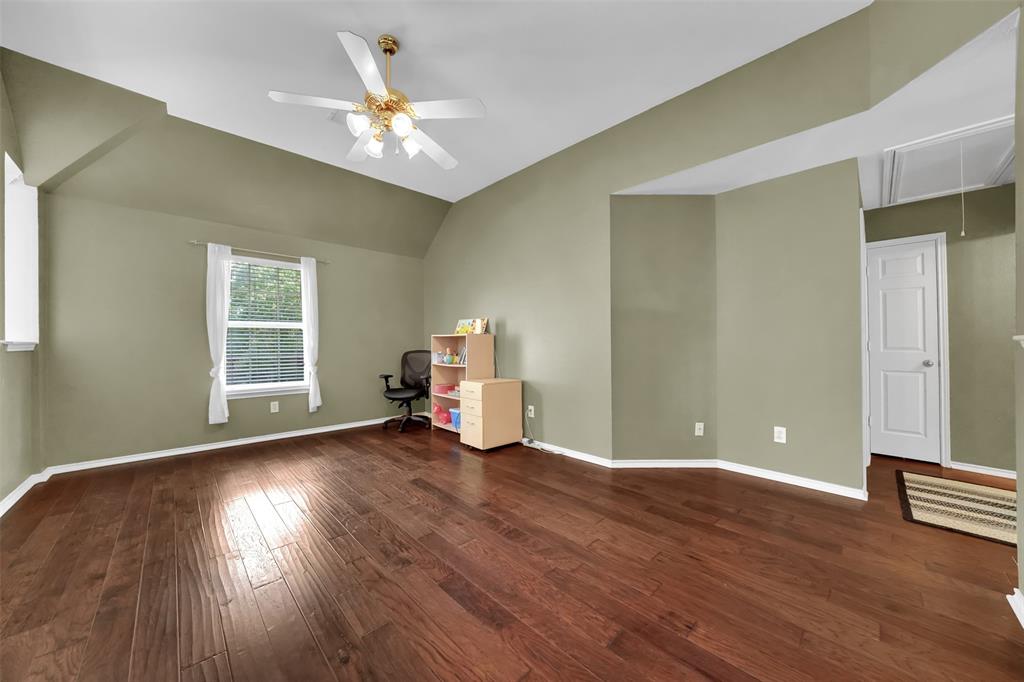 1333 Lighthouse Lane Allen, TX 75013 - Photo 28 of 40 a view of a livingroom with wooden floor and a ceiling fan