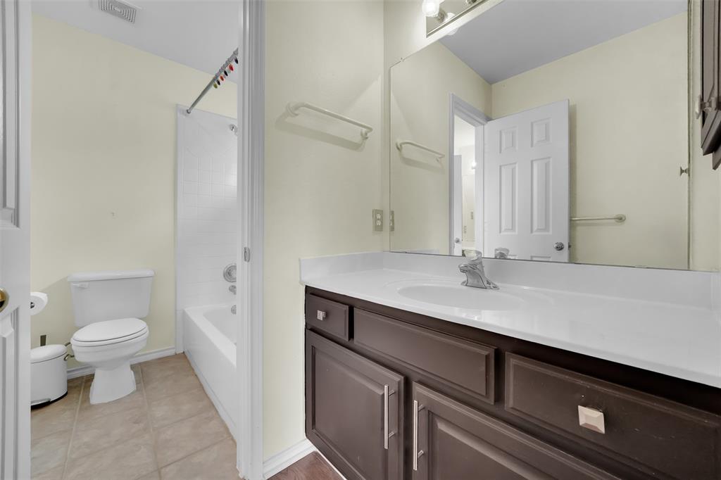 1333 Lighthouse Lane Allen, TX 75013 - Photo 33 of 40 a bathroom with a sink a toilet a shower and a mirror