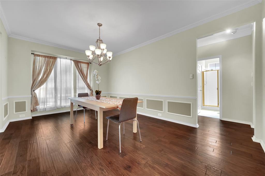 1333 Lighthouse Lane Allen, TX 75013 - Photo 5 of 40 a dining room with wooden floor a chandelier a glass table and chairs