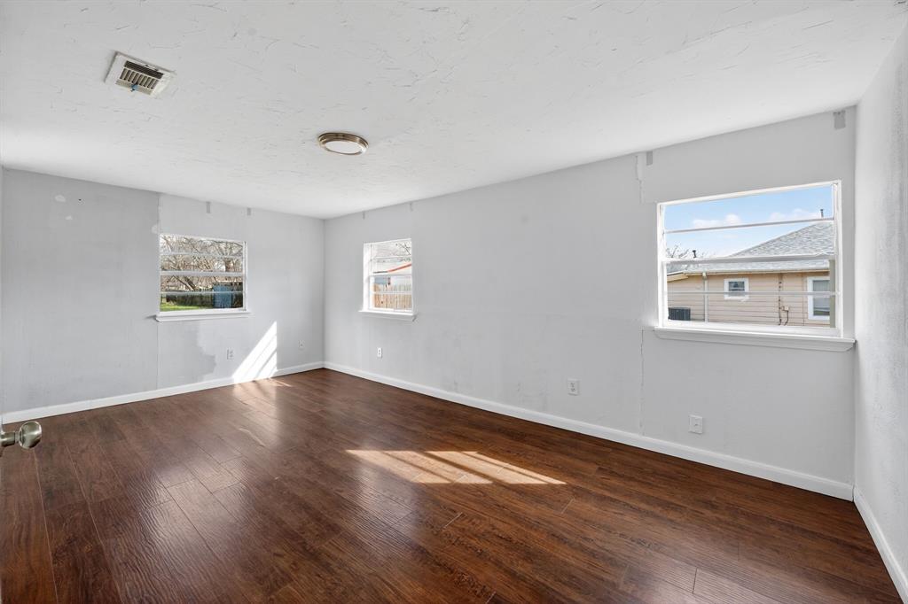 130 Center Street Nevada, TX 75173 - Photo 16 of 32 a view of an empty room with wooden floor and a window