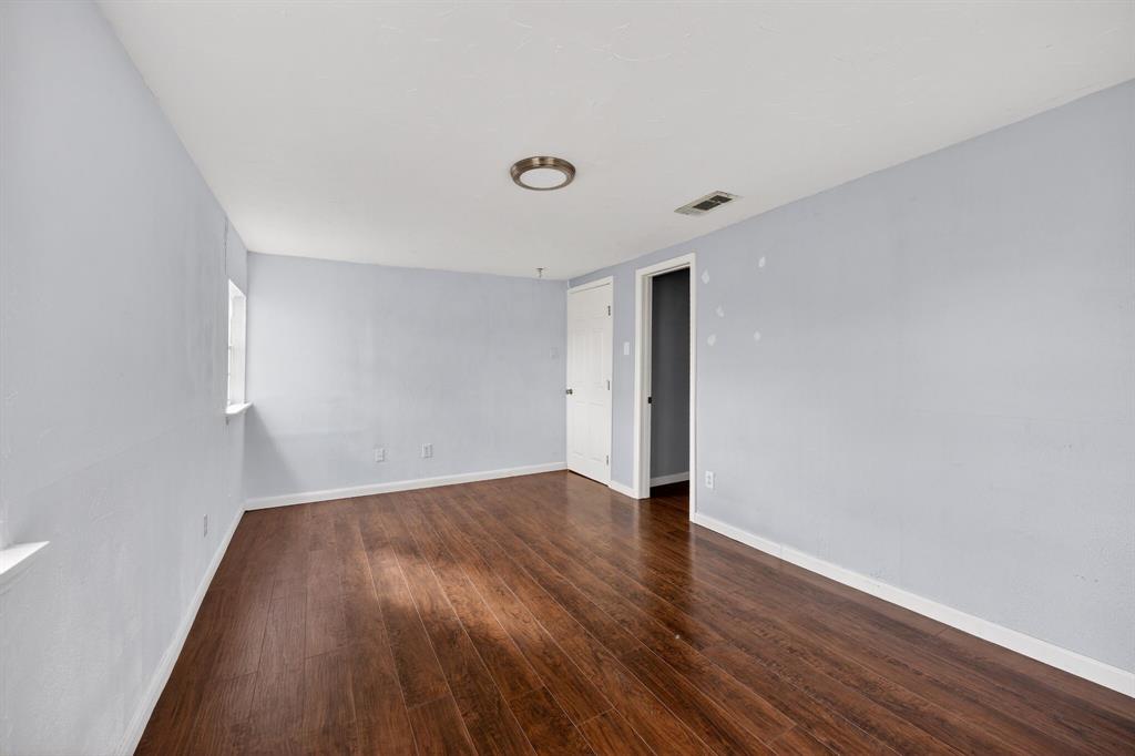 130 Center Street Nevada, TX 75173 - Photo 17 of 32 a view of an empty room with wooden floor