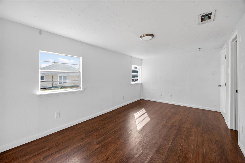 130 Center Street Nevada, TX 75173 - Photo 18 of 32 a view of an empty room with wooden floor and a window