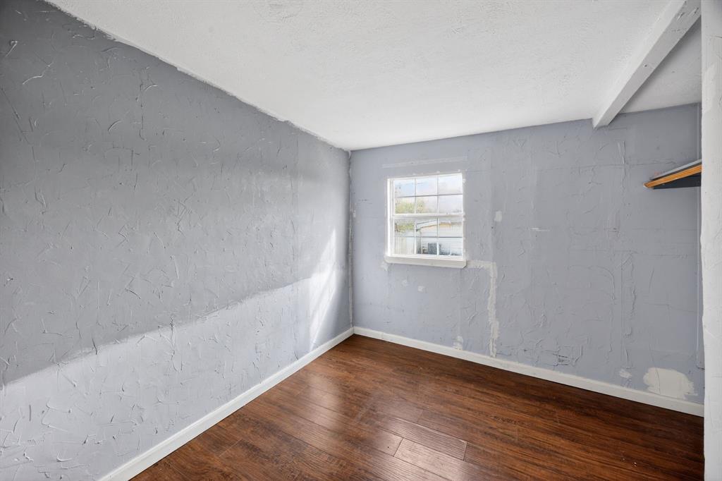 130 Center Street Nevada, TX 75173 - Photo 20 of 32 a view of an empty room with wooden floor and a window