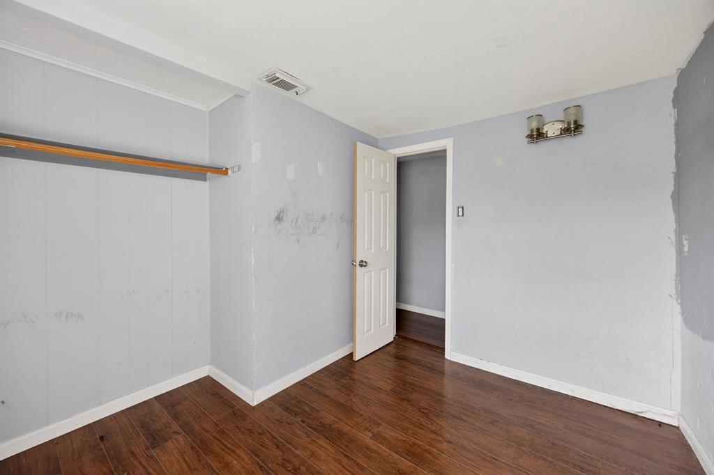 130 Center Street Nevada, TX 75173 - Photo 21 of 32 a view of an empty room with wooden floor