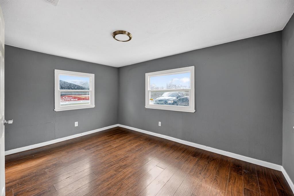 130 Center Street Nevada, TX 75173 - Photo 22 of 32 a view of room with wooden floor and window