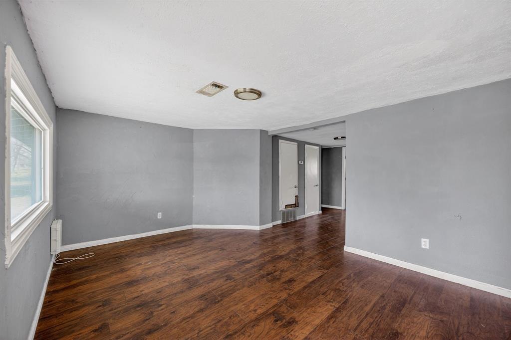 130 Center Street Nevada, TX 75173 - Photo 24 of 32 a view of an empty room with wooden floor and a window