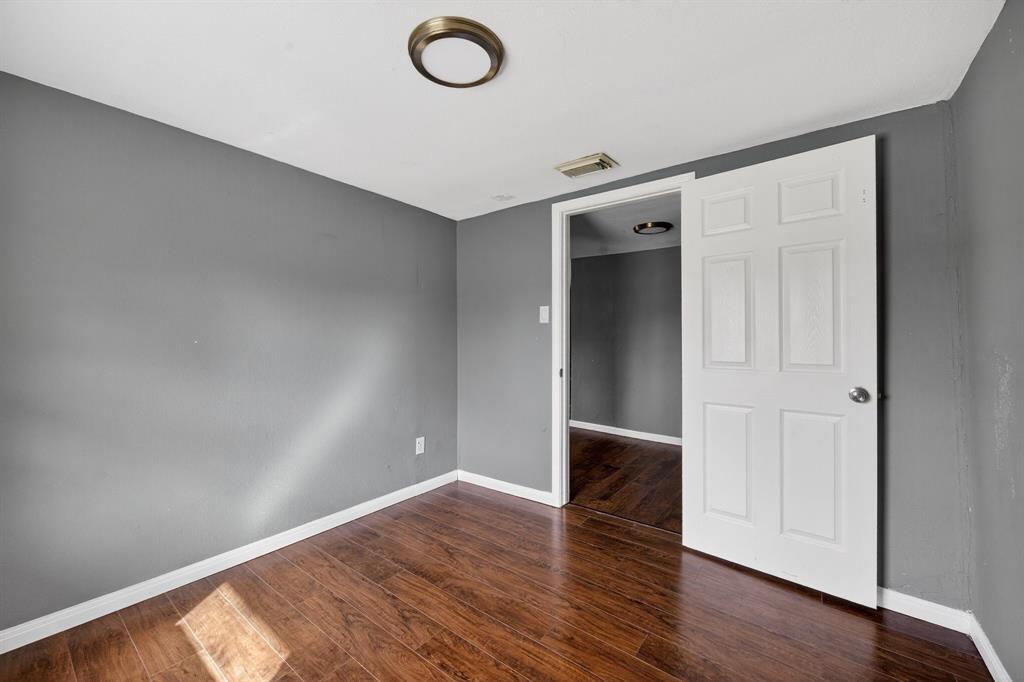 130 Center Street Nevada, TX 75173 - Photo 26 of 32 a view of an empty room with wooden floor