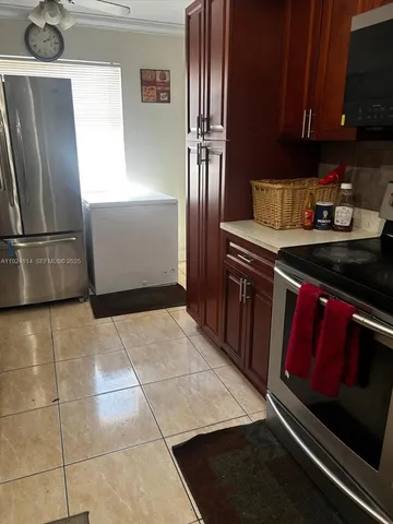 a view of a patio with a table chairs and wooden floor