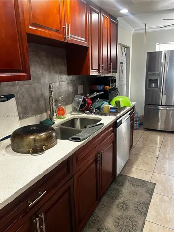 a view of a yard with plants and trees