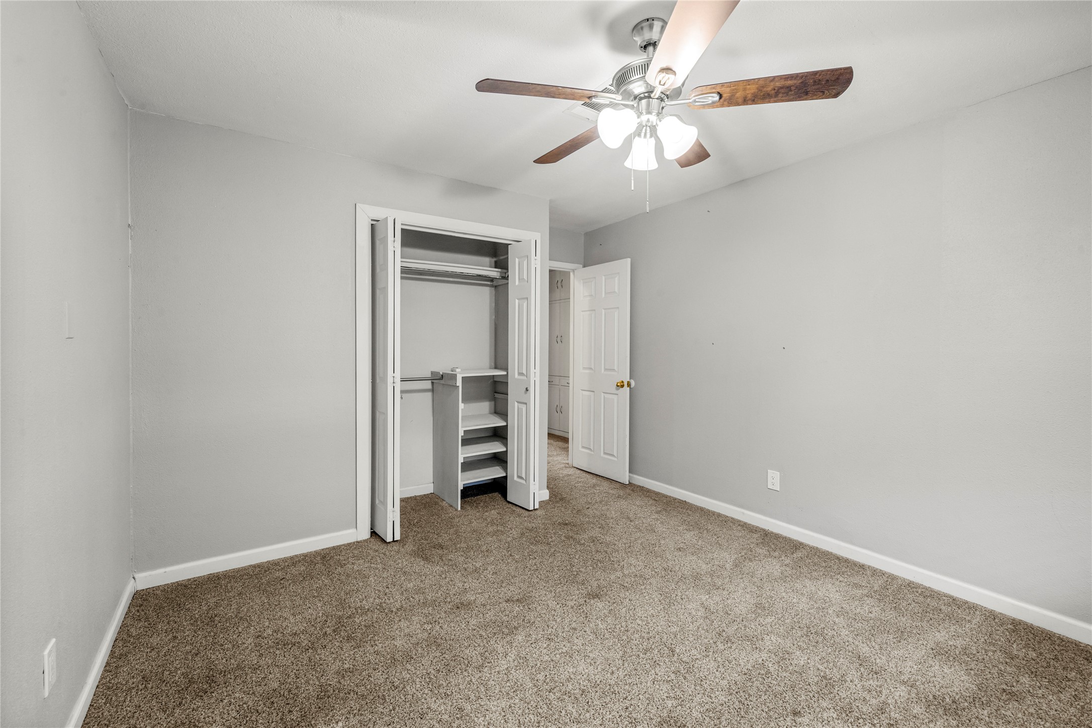 1401 Brazos Street Marble Falls, TX 78654 - Photo 11 of 23 Unfurnished bedroom featuring carpet, a closet, and ceiling fan