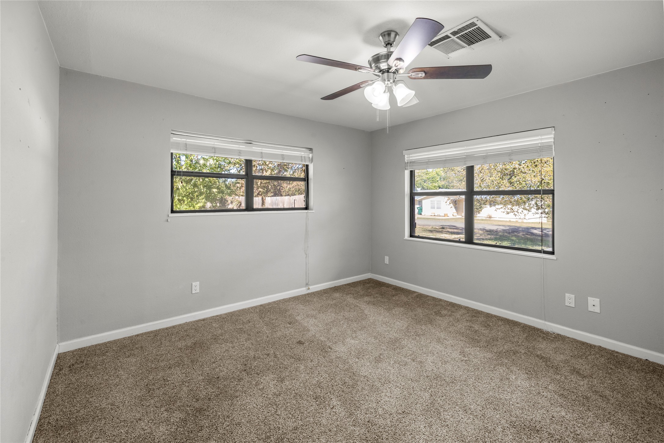 1401 Brazos Street Marble Falls, TX 78654 - Photo 13 of 23 Carpeted spare room featuring plenty of natural light and ceiling fan