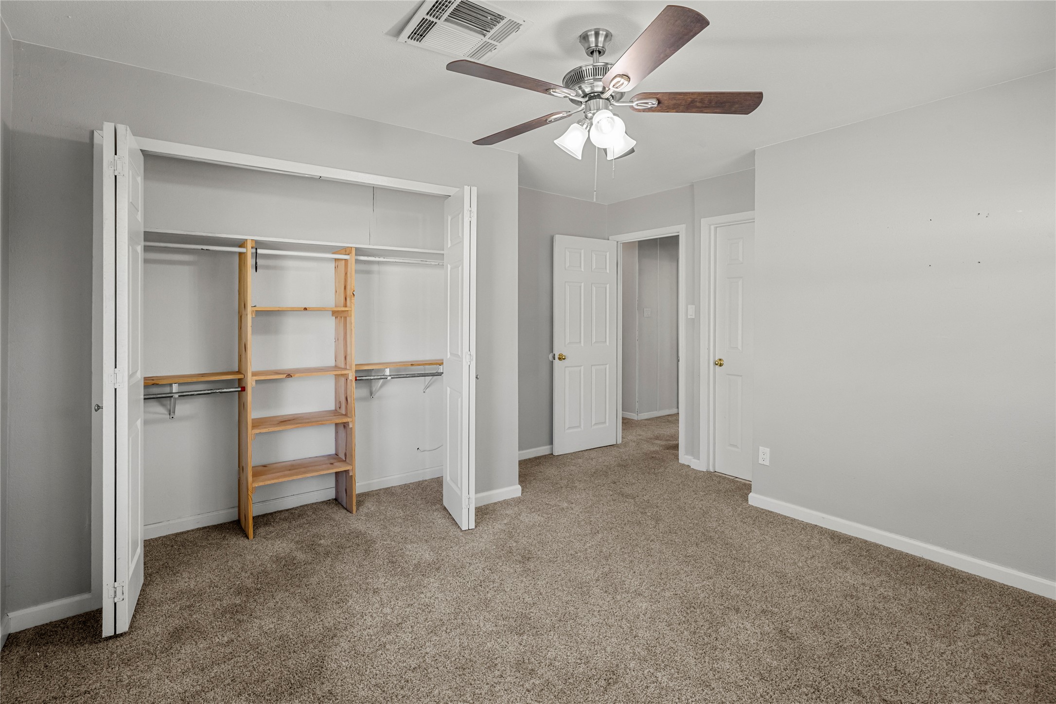 1401 Brazos Street Marble Falls, TX 78654 - Photo 14 of 23 Unfurnished bedroom with light colored carpet, a closet, and ceiling fan