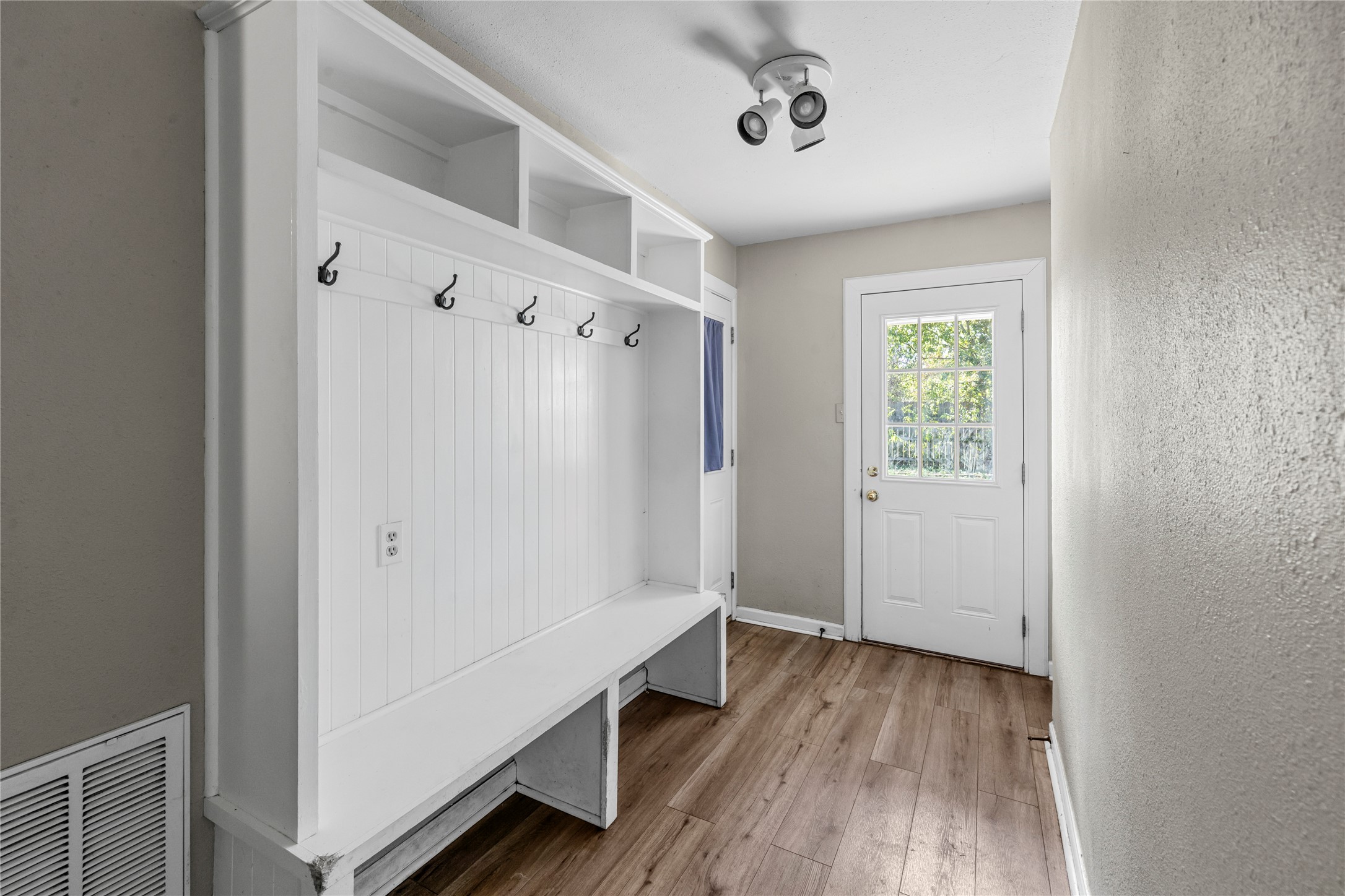 1401 Brazos Street Marble Falls, TX 78654 - Photo 16 of 23 Mudroom with light wood-style flooring and a textured wall