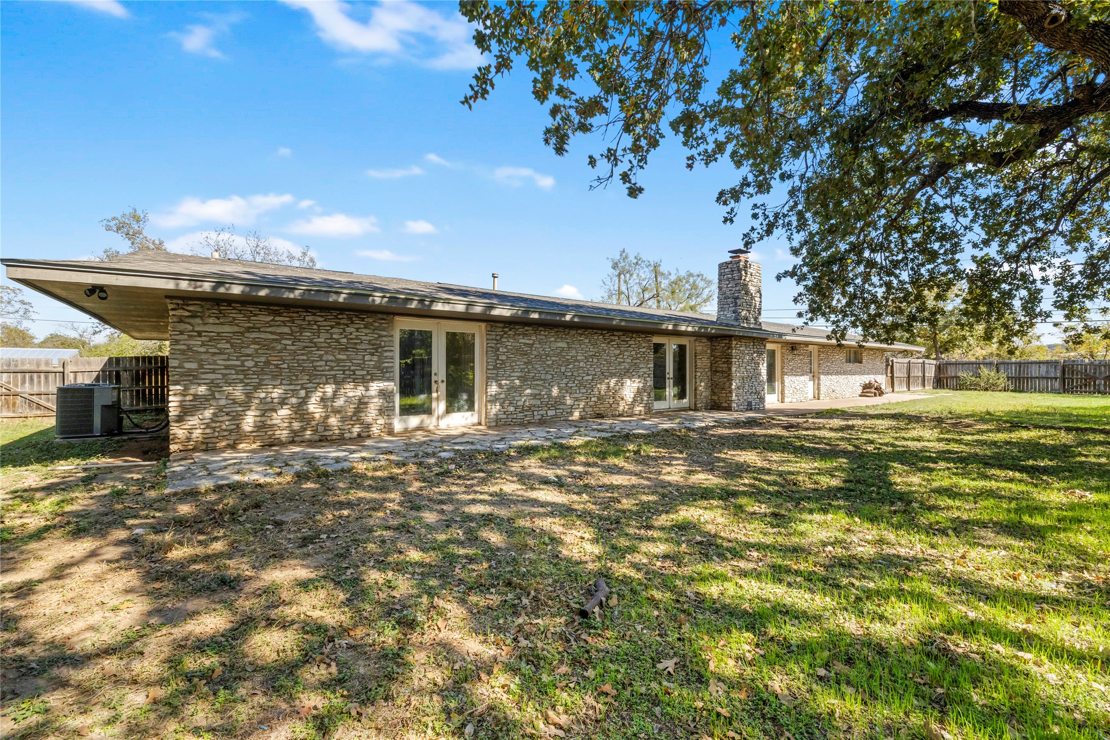 1401 Brazos Street Marble Falls, TX 78654 - Photo 21 of 23 Rear view of property with a patio area, a chimney, brick siding, and french doors