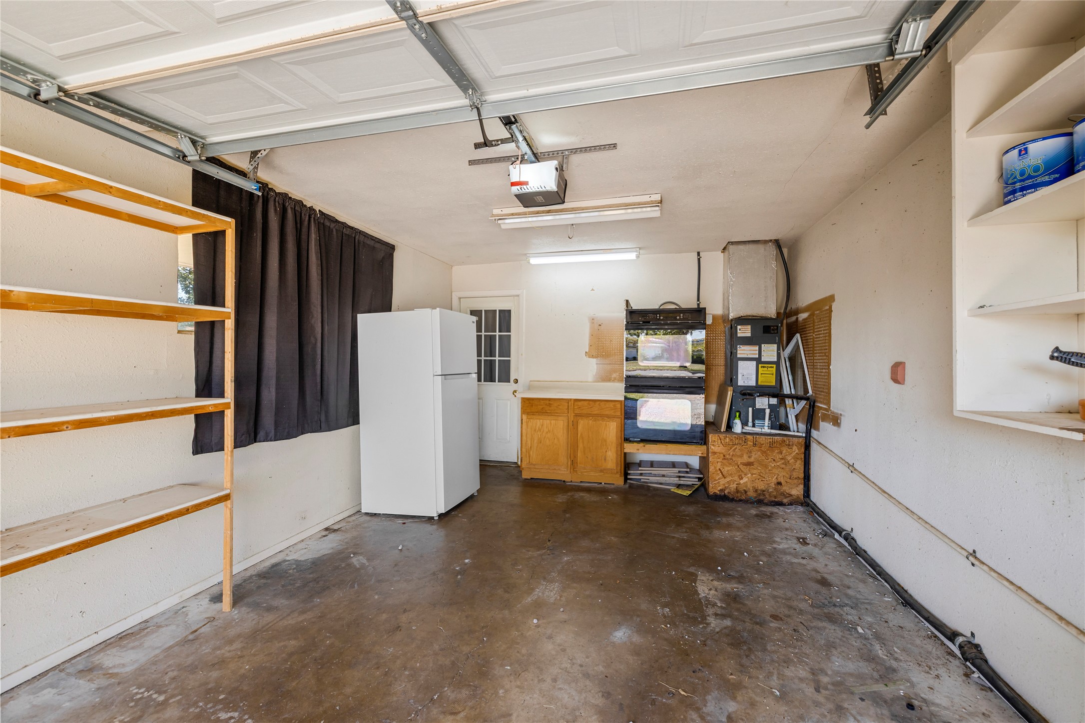 1401 Brazos Street Marble Falls, TX 78654 - Photo 23 of 23 Garage featuring freestanding refrigerator and a garage door opener