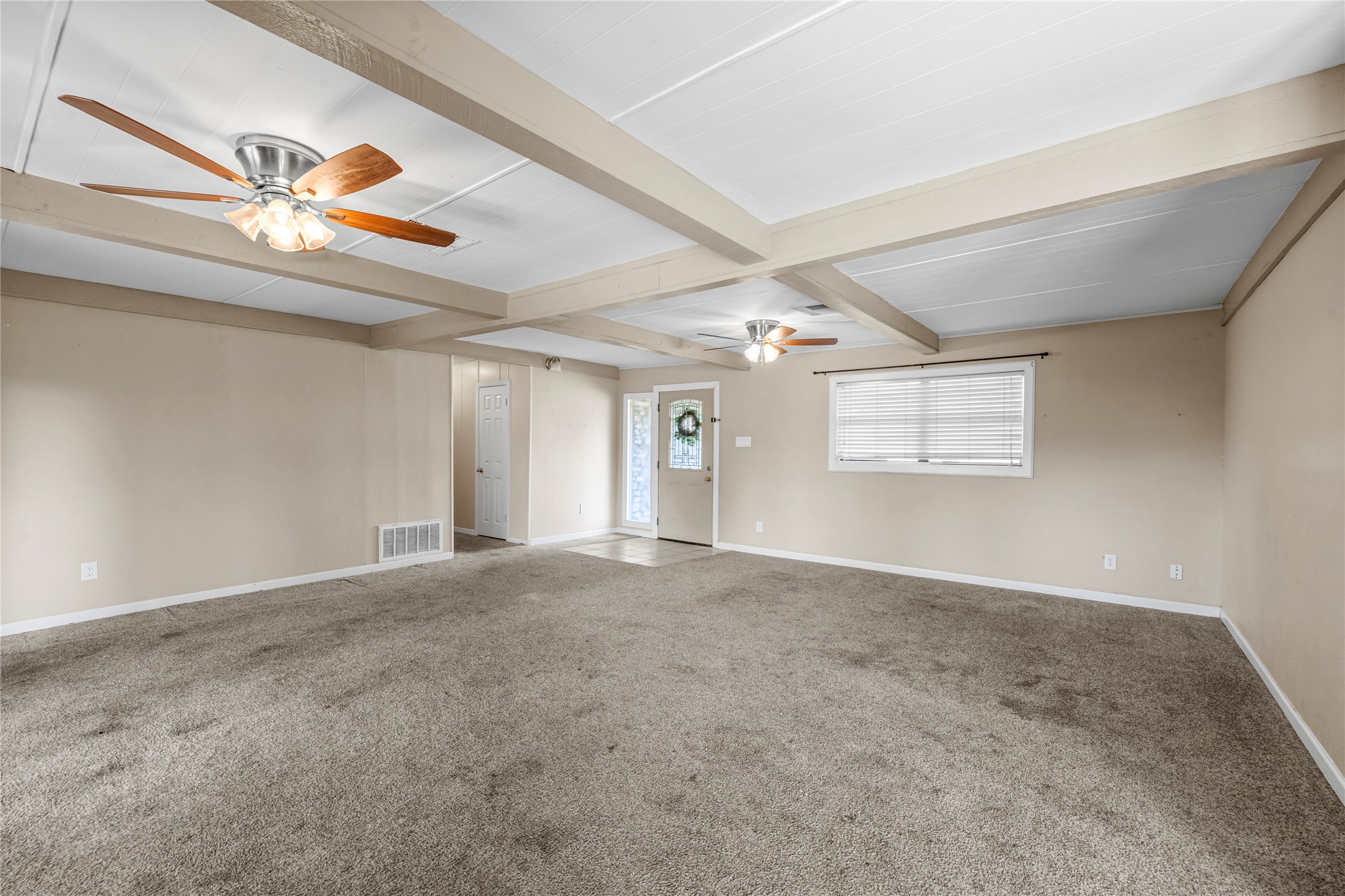 1401 Brazos Street Marble Falls, TX 78654 - Photo 4 of 23 Unfurnished room with beam ceiling, carpet floors, and ceiling fan