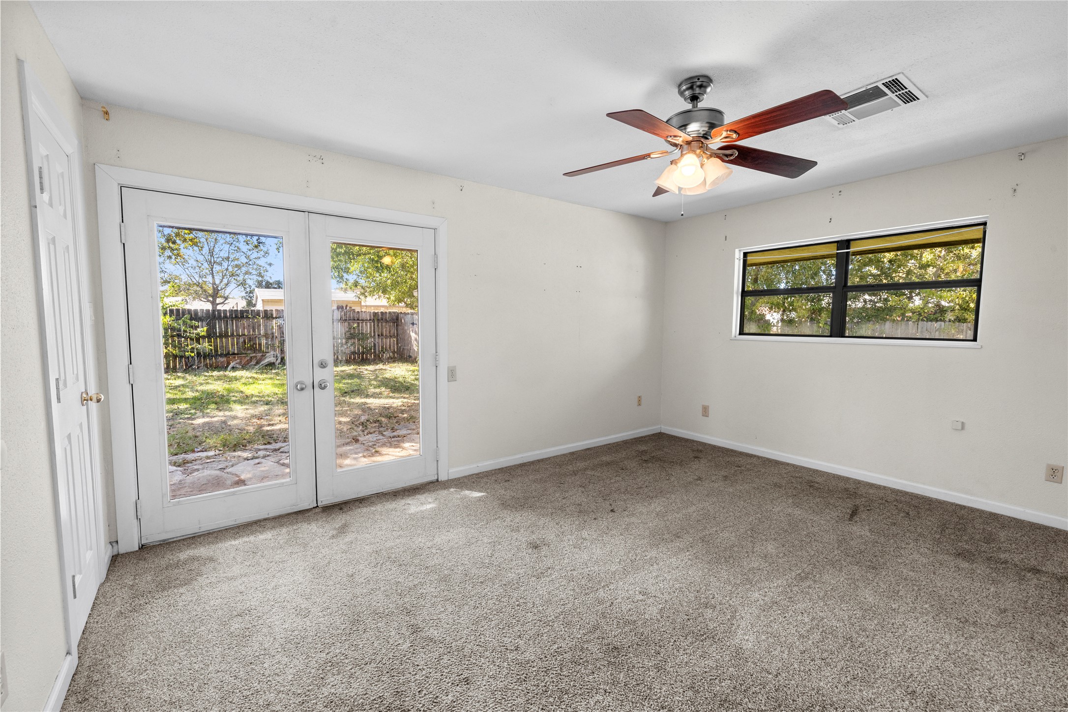 1401 Brazos Street Marble Falls, TX 78654 - Photo 9 of 23 Spare room with carpet flooring, french doors, and ceiling fan