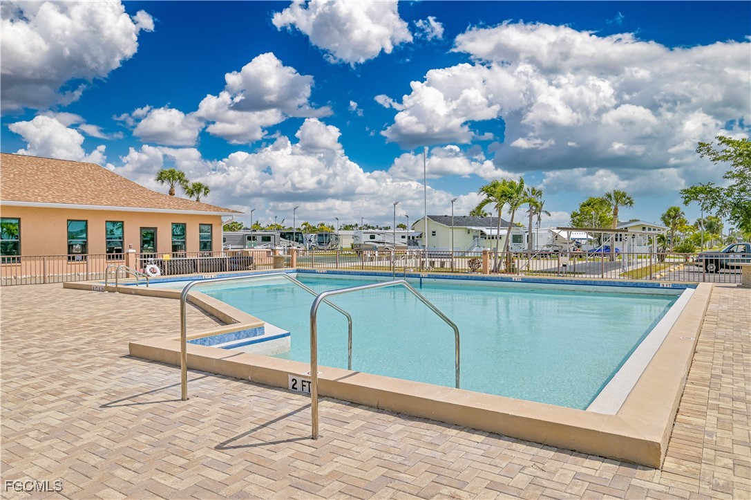 19681 Summerlin Road, Unit 273 Fort Myers, FL 33908 - Photo 11 of 16 a view of a swimming pool with a lounge chairs